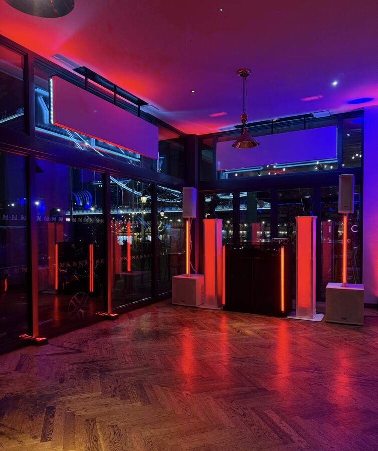 Red and purple lighting setup with DJ booth